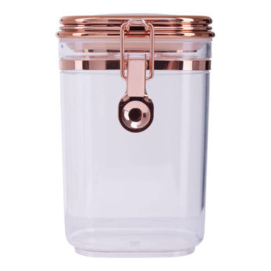 Clear jar with rose gold lid and clasp on a white background