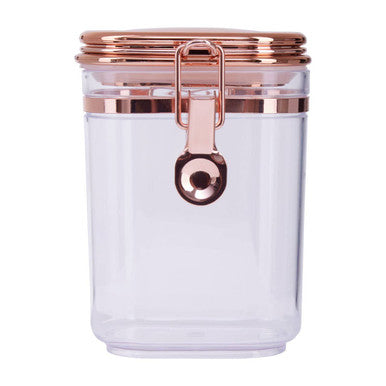 Clear jar with rose gold lid and handle on a white background