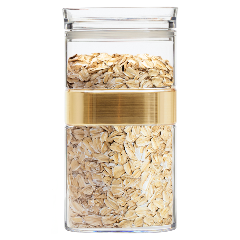 Clear glass jar with gold lid containing rolled oats on a white background
