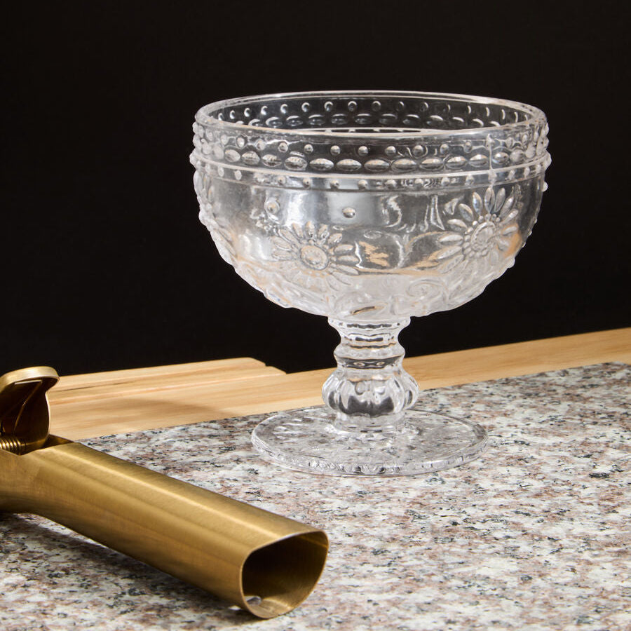 Decorative glass bowl with textured design on a dark background