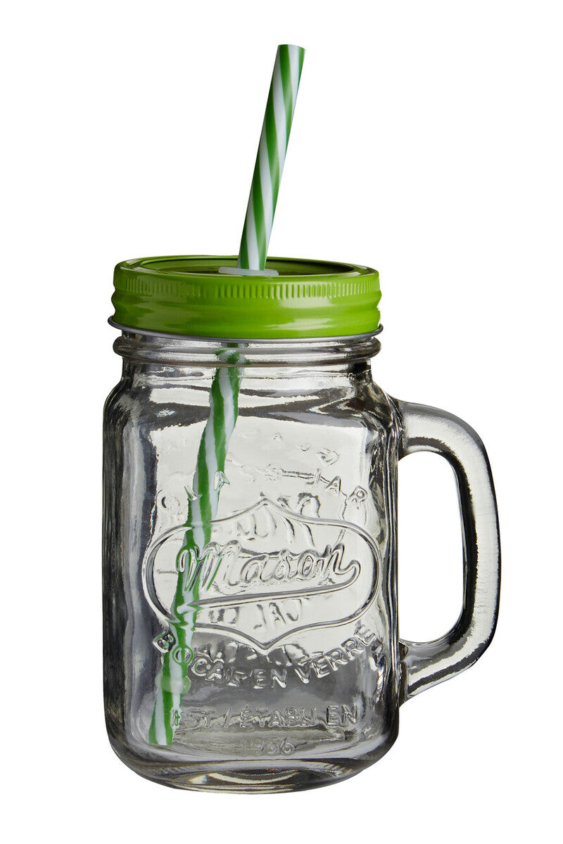 Clear glass mason jar with green lid and straw on a white background