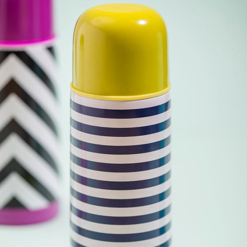 Striped thermos with yellow lid on a white background