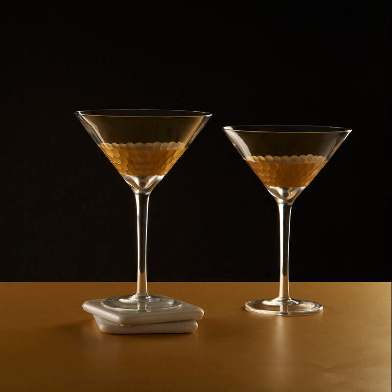 Two martini glasses with a dark background