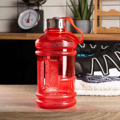 Red water bottle on a kitchen counter with sneakers and a scale in the background