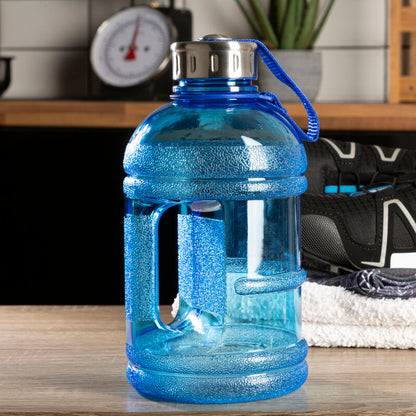 Blue water bottle on a table with sneakers and towel in the background