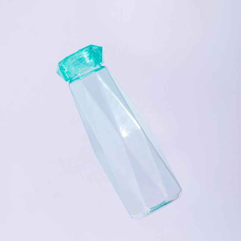 Clear water bottle with a green cap on a light purple background