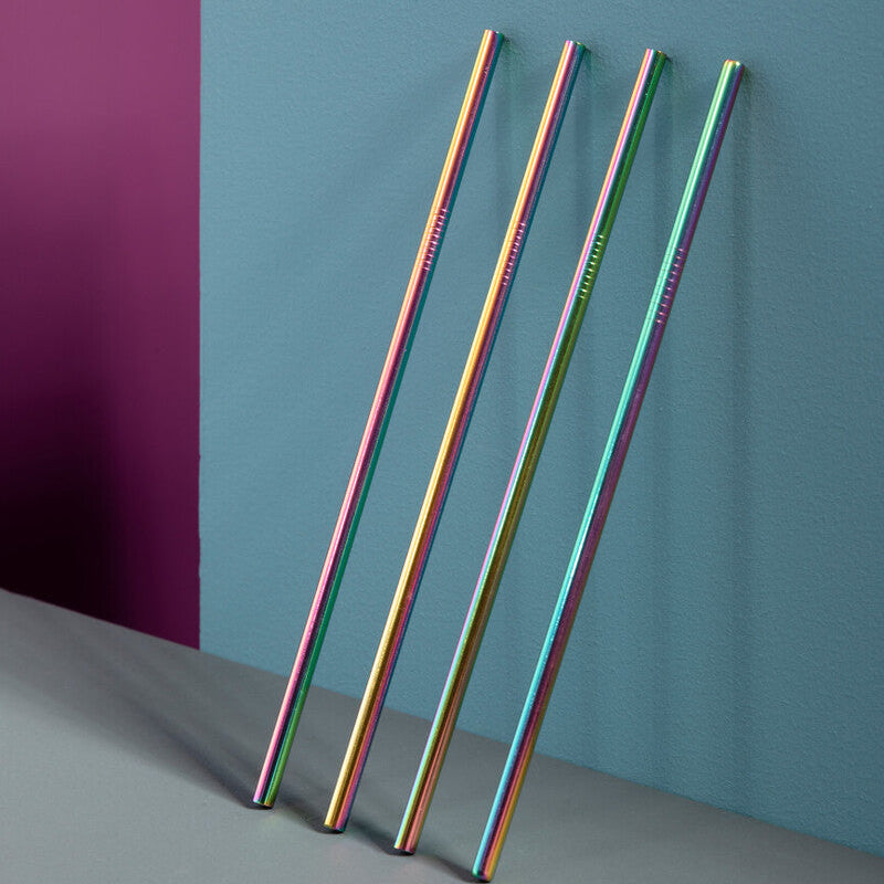 Set of colorful metal straws against a multicolored background