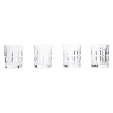 Four clear glass tumblers on a white background