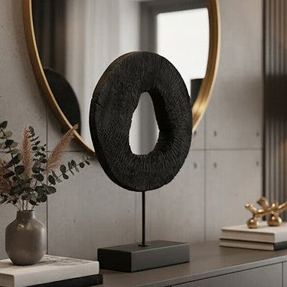 Modern interior with a dresser, round mirror, and decorative items.
