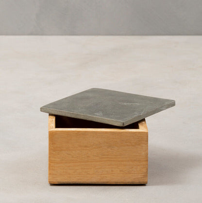 Wooden box with a concrete top on a plain background