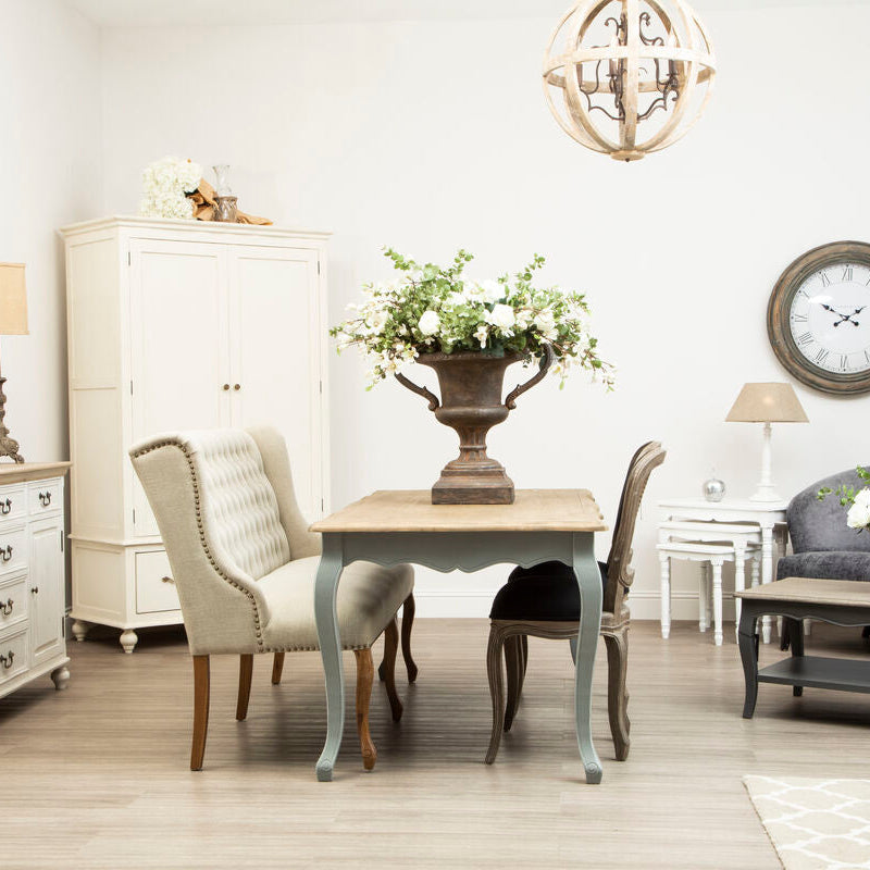 Living room with furniture including a sofa, table, and chairs.