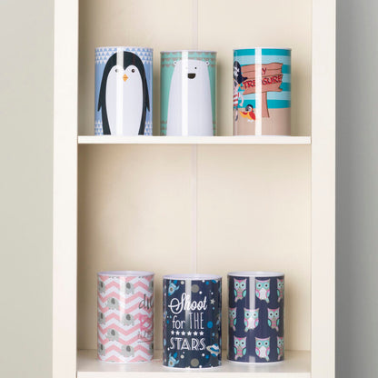 Set of colorful mugs on a white shelf against a gray wall