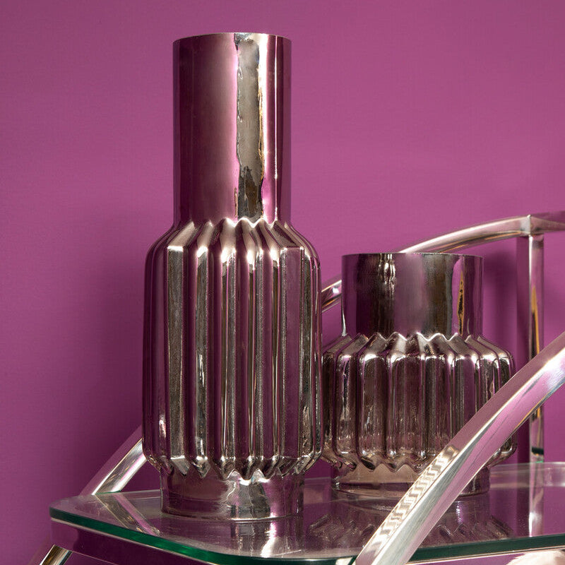 Silver vase with textured design on a white background