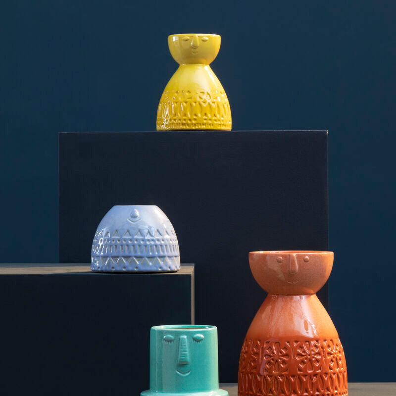 Collection of textured ceramic vases in various colors on a dark background