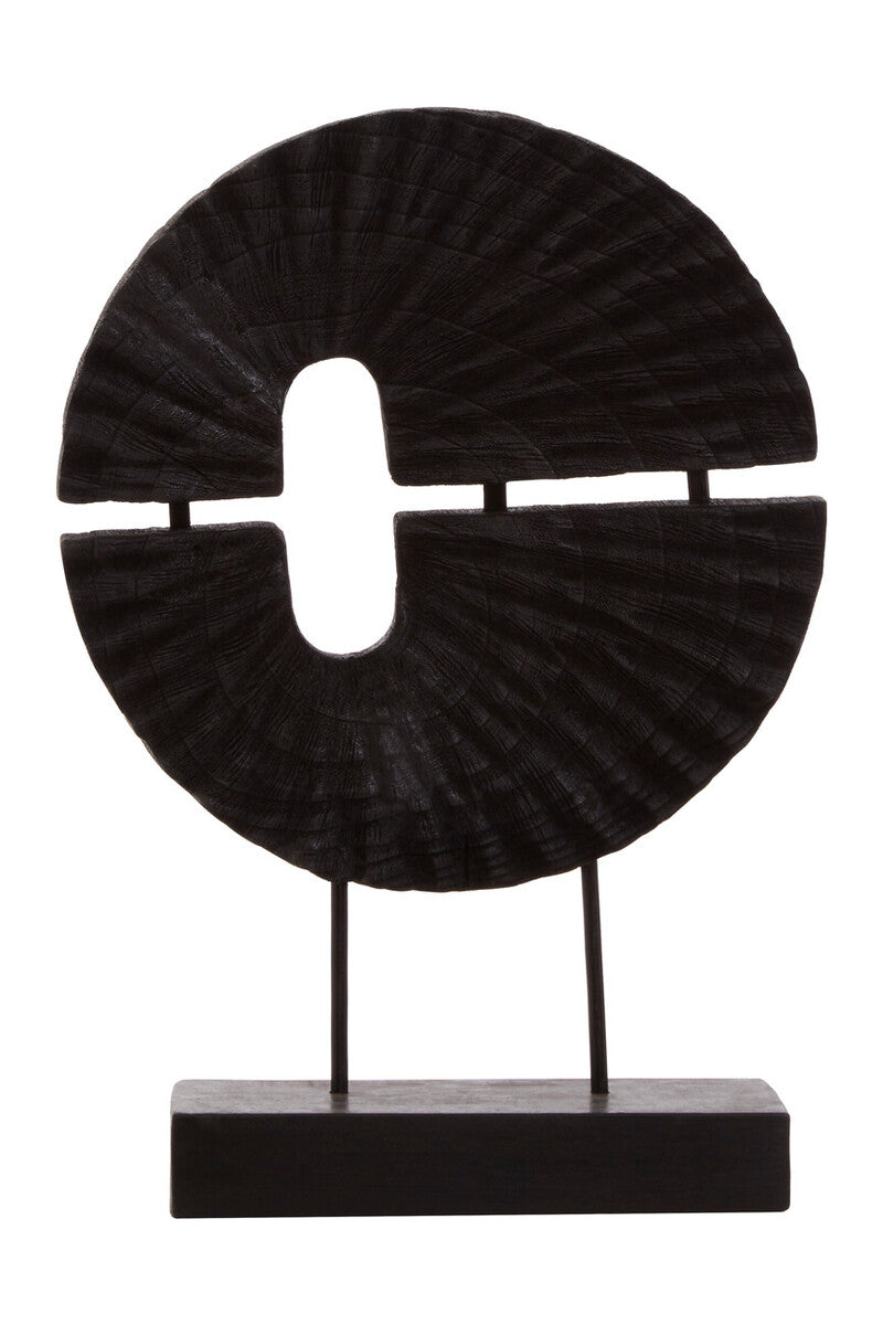 Black circular decorative object on a stand against a white background