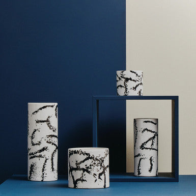 Ceramic vases with abstract designs on a blue and white background