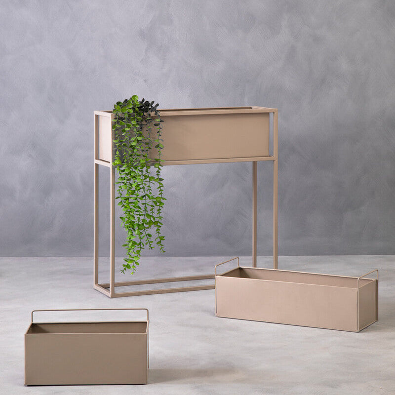 Set of beige metal planters against a gray wall