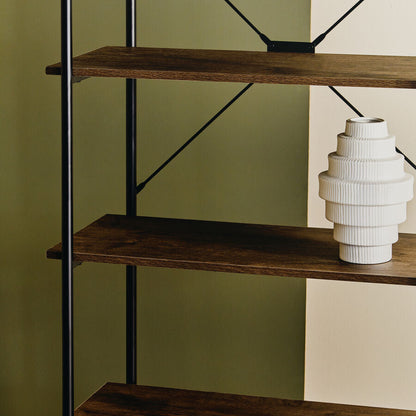 Wooden shelf with black metal legs against a green wall