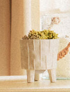 Wooden chair with wicker backrest in a room with a desk and window.