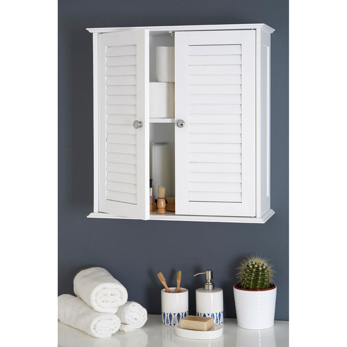 White wall-mounted cabinet with open doors, displaying bathroom items against a dark gray wall.