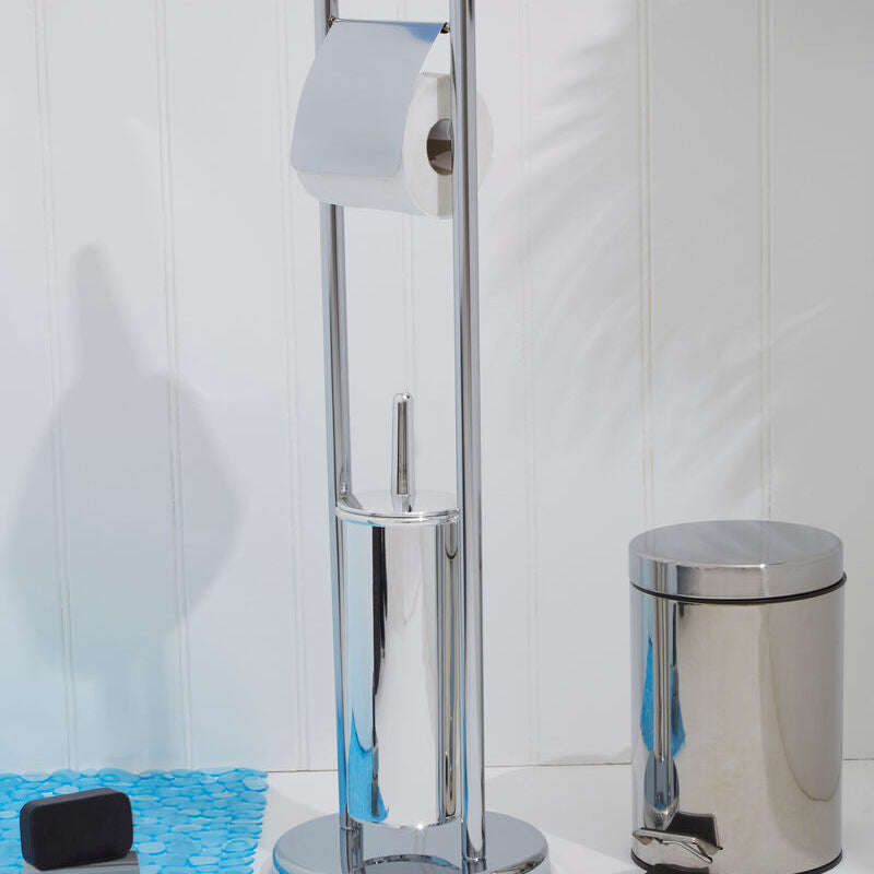 Chrome toilet paper holder and trash can on a white floor with a light blue rug.
