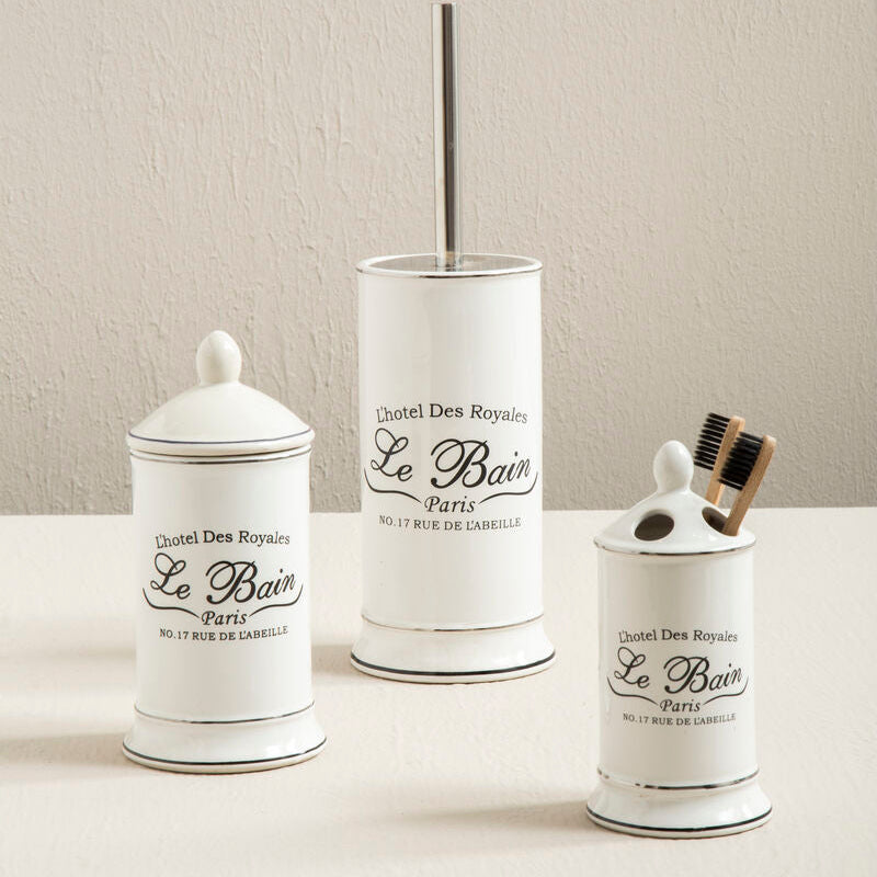 Set of three white bathroom containers with black text on a neutral background