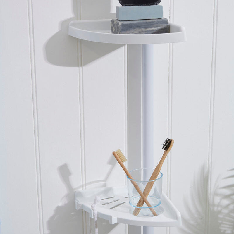 Corner shower caddy with soap, shampoo bottles, and toothbrushes on a white wall.