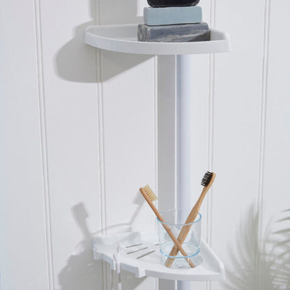 Corner shower caddy with soap, shampoo bottles, and toothbrushes on a white wall.