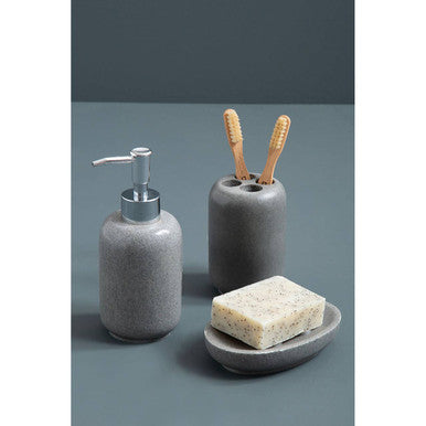Ceramic bathroom set with soap dispenser, toothbrush holder, and soap dish on a gray background