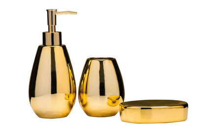 Set of gold bathroom accessories including a soap dispenser and two containers on a white background