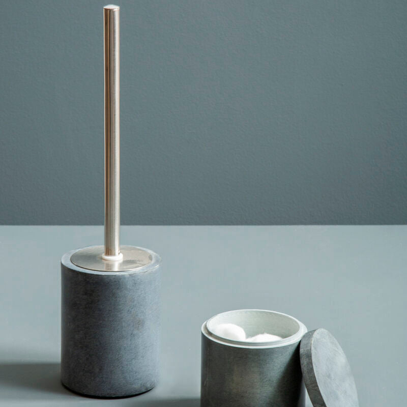 Bathroom accessories set with concrete containers and a brush on a gray background