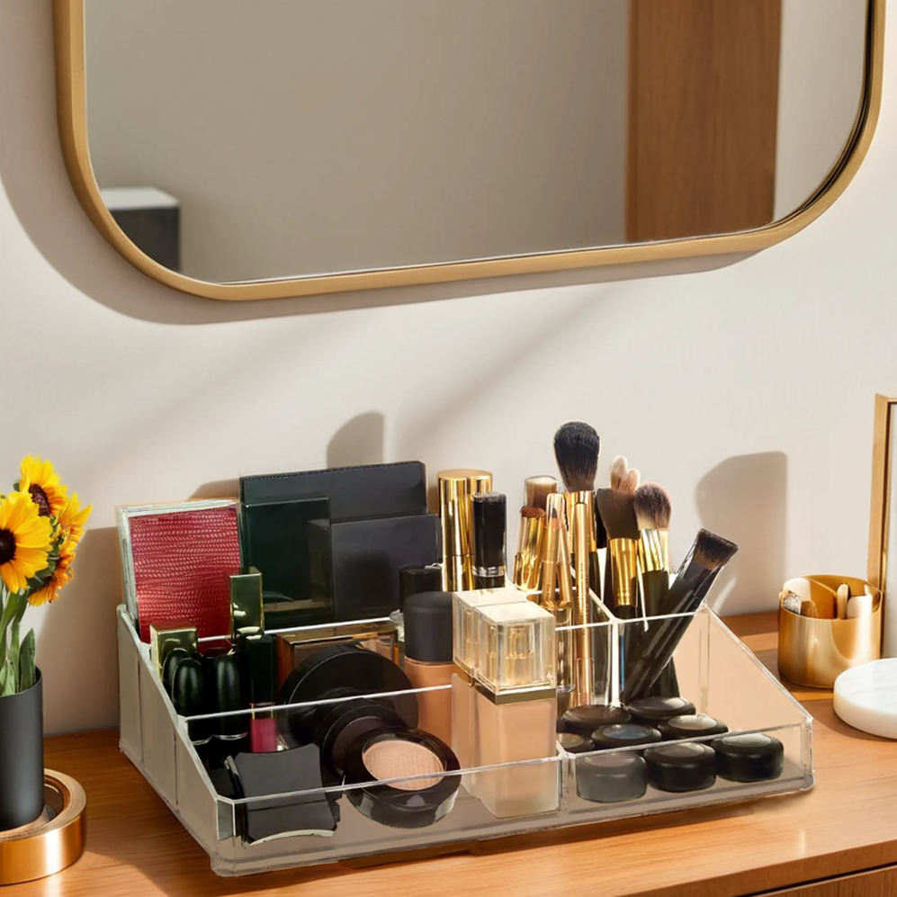 Makeup organizer on a vanity with various cosmetic items and a mirror in the background.