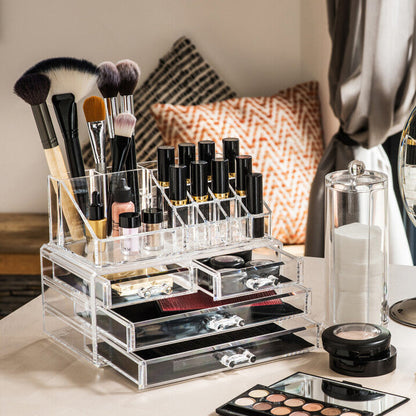 Makeup brushes, products, and a mirror on a vanity table.