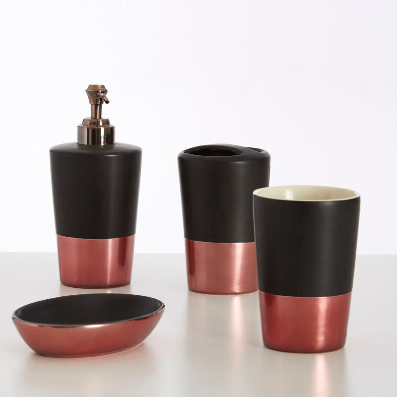 Bathroom accessory set with black and rose gold finish on a white background