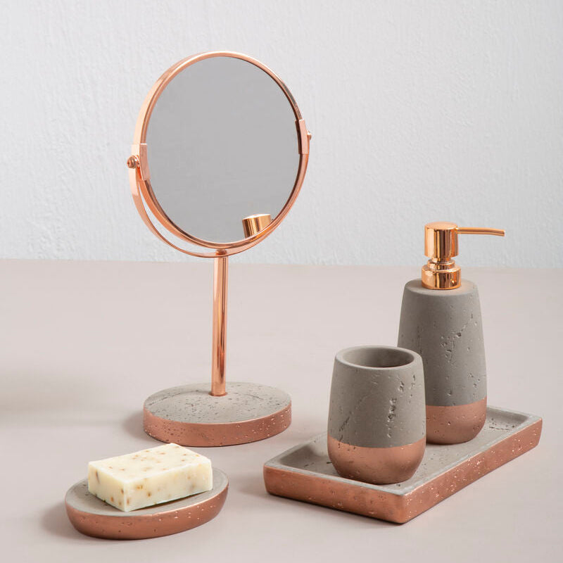 Bathroom accessories including a mirror, soap dish, and containers on a neutral background