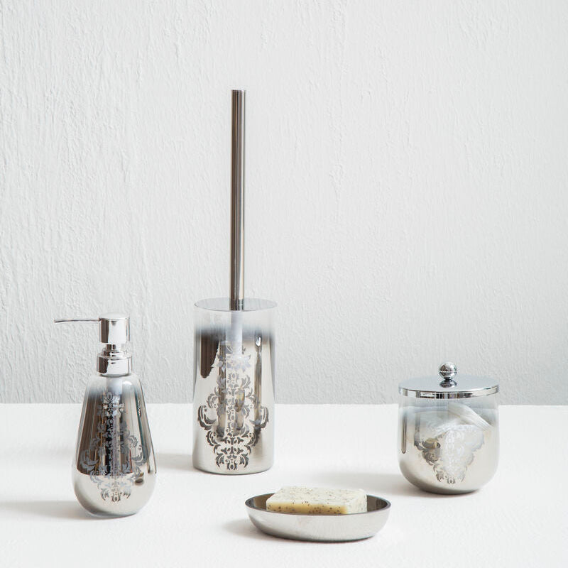 Set of silver bathroom accessories including a soap dispenser, toothbrush holder, and jar on a white surface with a light gray background.