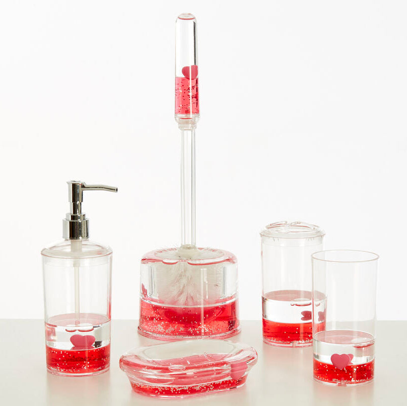 Bathroom accessory set with red liquid in clear containers on a white background