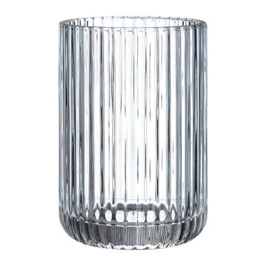 Clear glass vase with vertical ribbing on a white background