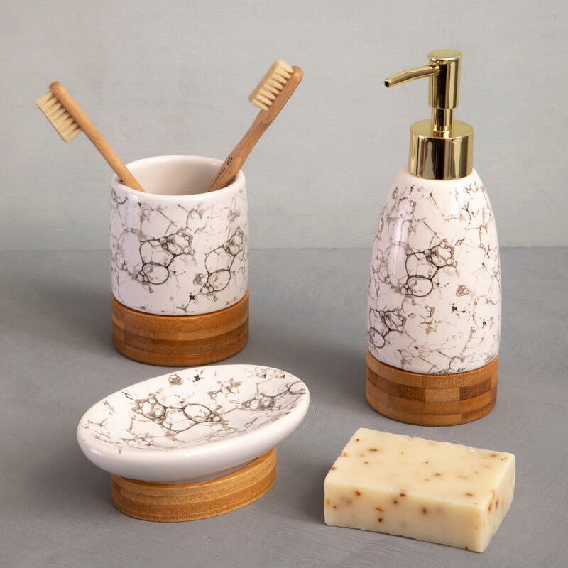 Bathroom accessory set with marble-patterned containers on a gray background