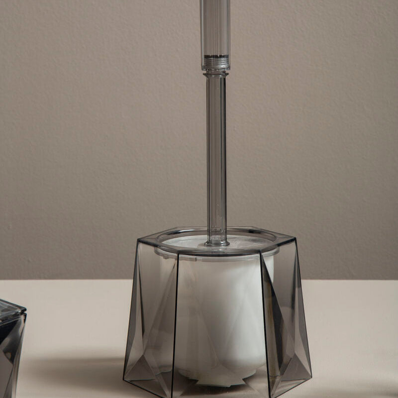 Decorative glass candle holder with geometric design on a neutral background