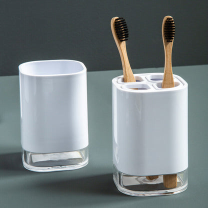 White toothbrush holder with bamboo toothbrushes on a gray surface