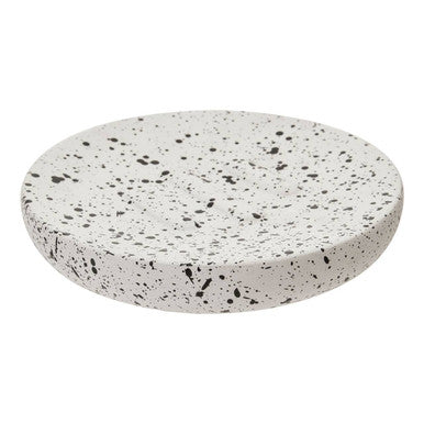 Round speckled stone coaster on a white background