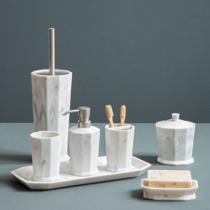 Marble-textured bathroom accessory set on a gray surface with a dark gray background