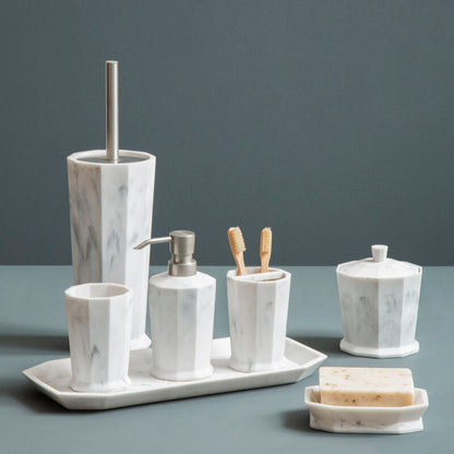 Marble-textured bathroom accessory set on a gray surface with a dark gray background