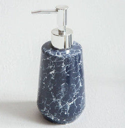 Blue marbled soap dispenser with silver pump on a white background