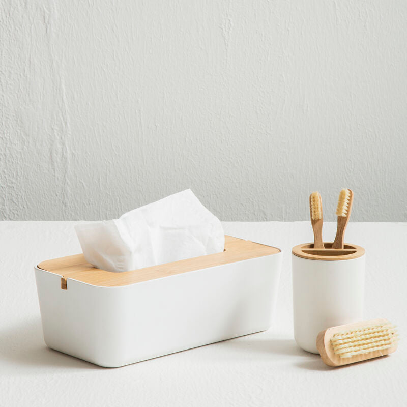 White tissue box with wooden tissue holder, toothbrush holder, and scrubber on a light surface.