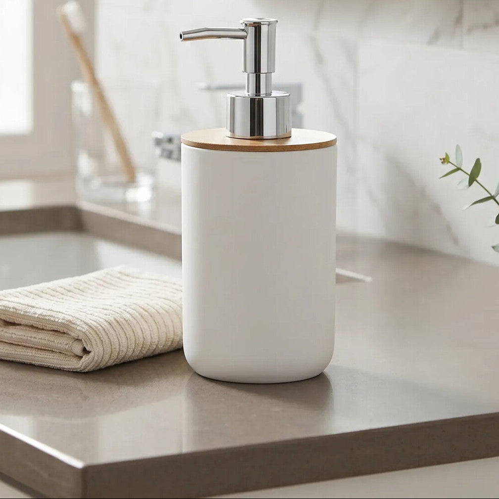 White soap dispenser with wooden top on a bathroom counter, featuring &