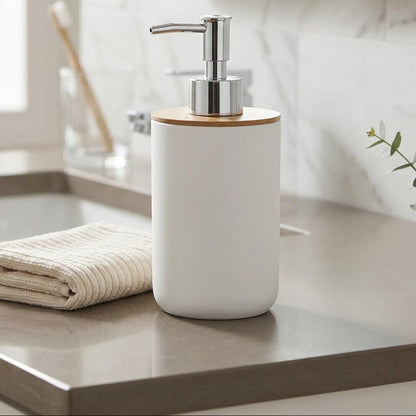 White soap dispenser with wooden top on a bathroom counter, featuring &