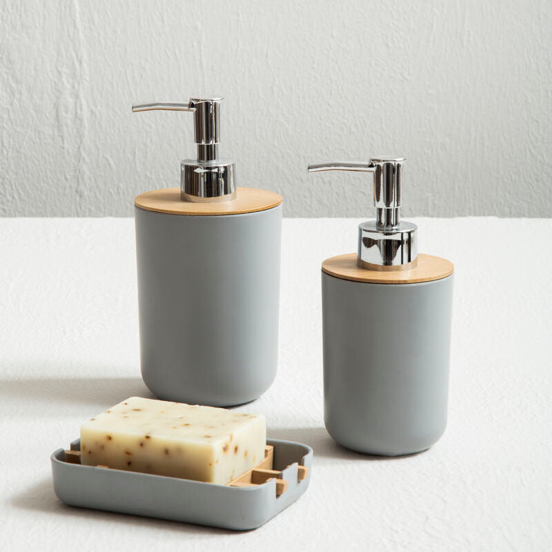 Two gray soap dispensers with wooden accents on a white surface.