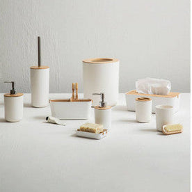 Set of bathroom accessories including cups, soap dishes, and a brush holder on a light gray background.
